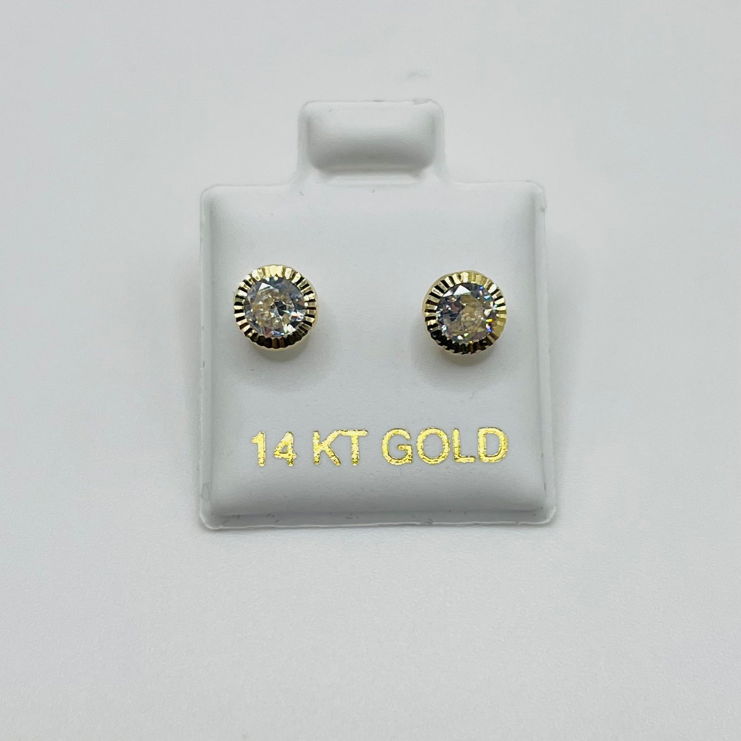 Gold earrings on a display card with '14 KT GOLD' text on a white background
