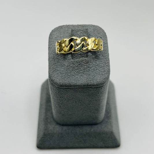 Gold chain ring on a gray stand with a light gray background