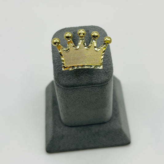 Gold crown-shaped object on a gray stand against a white background