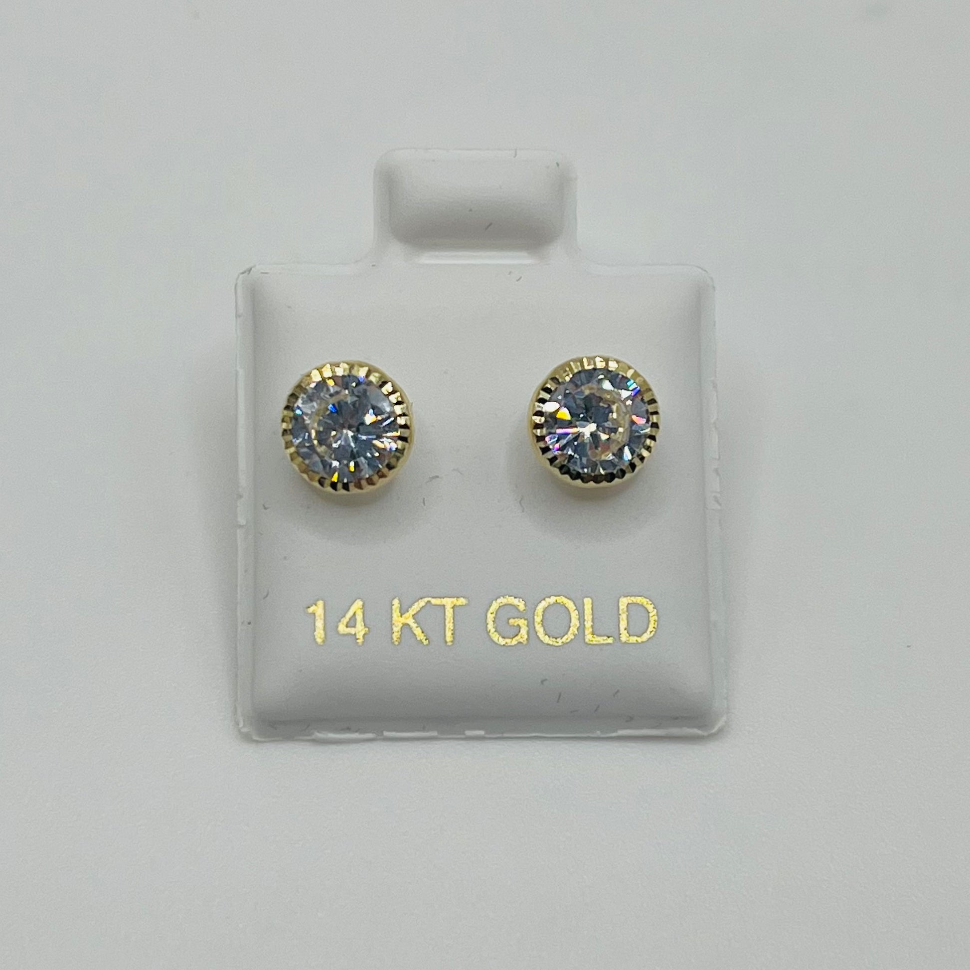 Pair of gold earrings with gemstones on a display card labeled '14 KT GOLD'.