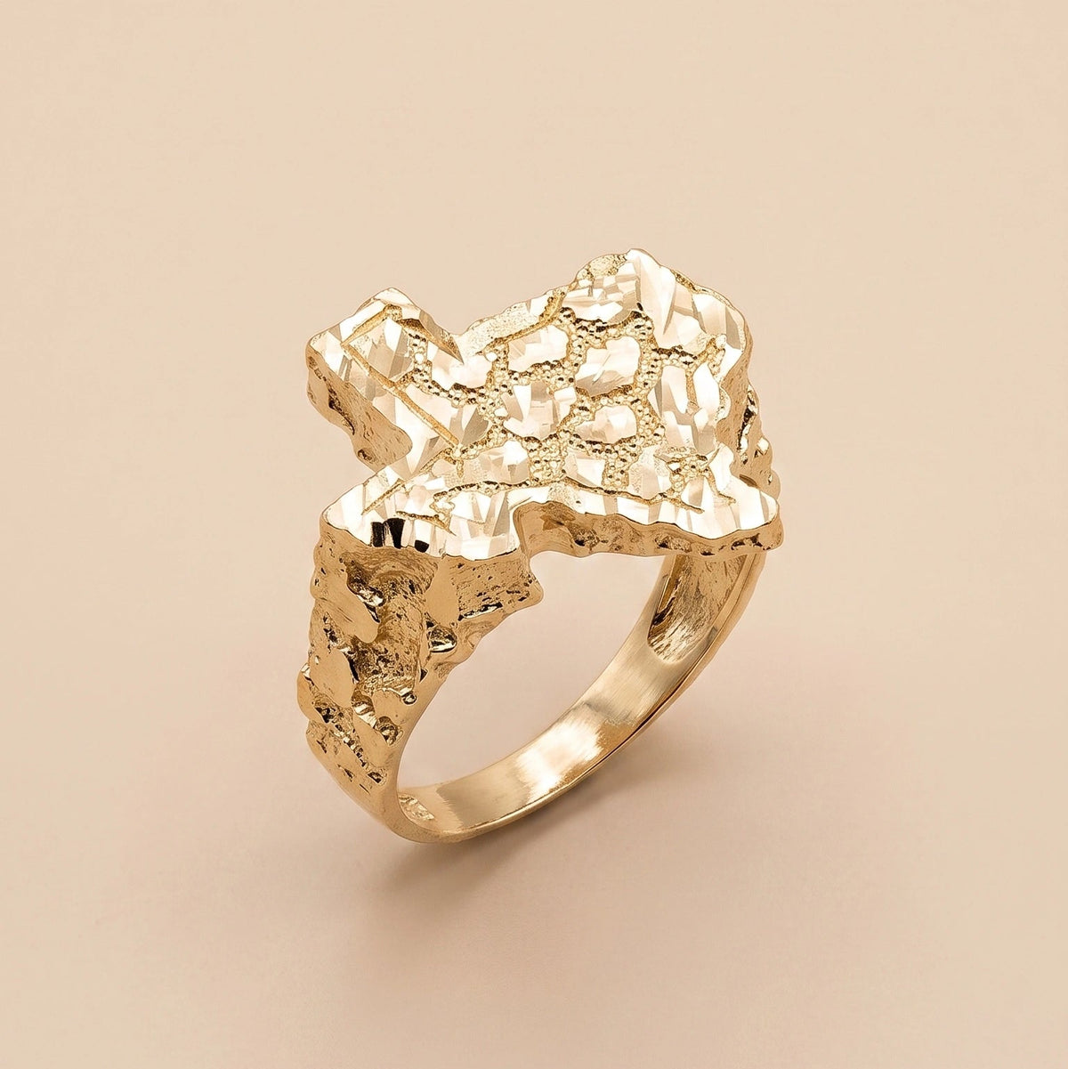 A 10K Gold Big Texas Nugget Ring with a sculptural, organic-shaped top, photographed on a solid beige background.