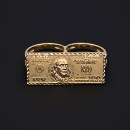 A novelty 10K gold two-finger ring featuring a detailed $100 bill design.