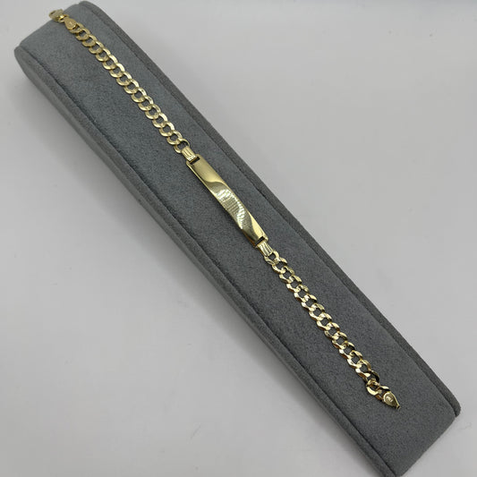 Gold chain in a gray jewelry box on a light gray background