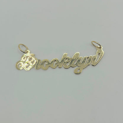 A 10K gold high polish nameplate necklace with the name 'Brooklynn' written in cursive script.