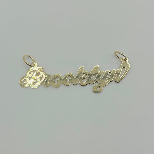 A 10K gold high polish nameplate necklace with the name 'Brooklynn' written in cursive script.