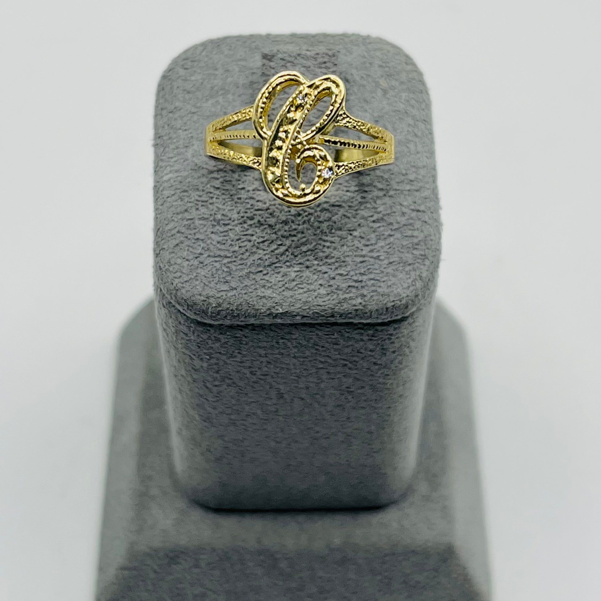 10 karat gold initial ring with cursive letters and small cz sotnes
