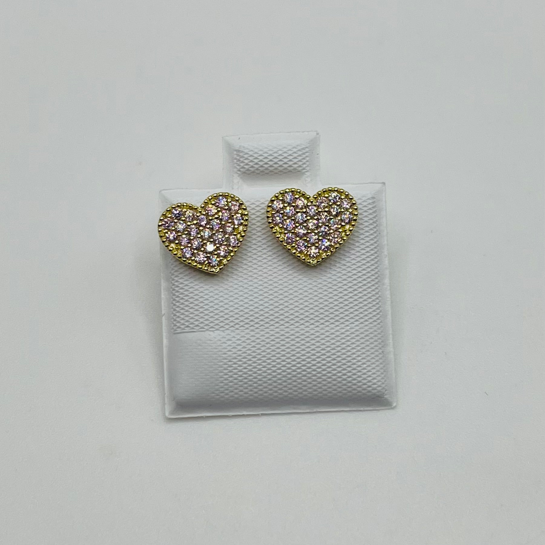 Heart-shaped earrings with gemstones on a white textured card