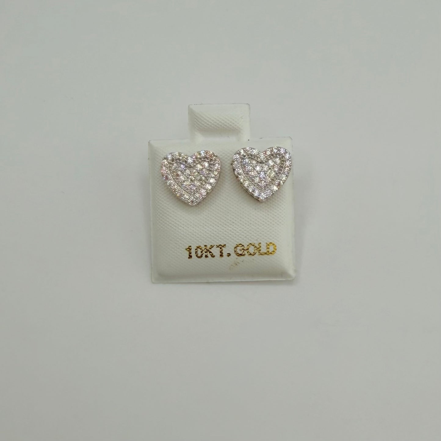 Heart-shaped earrings on a 10Kt Gold branded display card against a light gray background