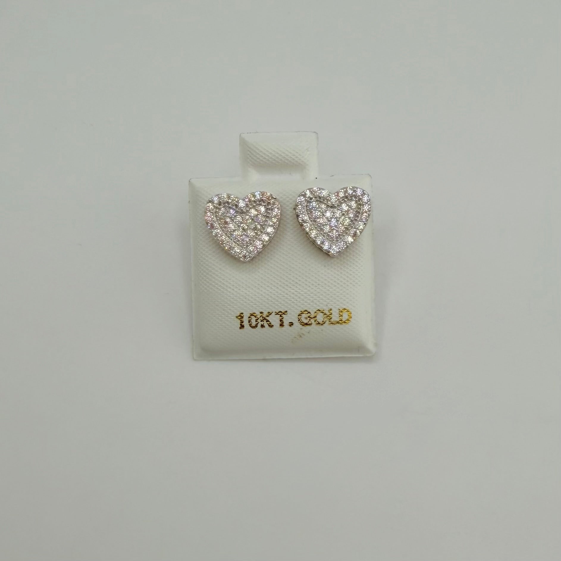 Heart-shaped earrings on a 10Kt Gold branded display card against a light gray background