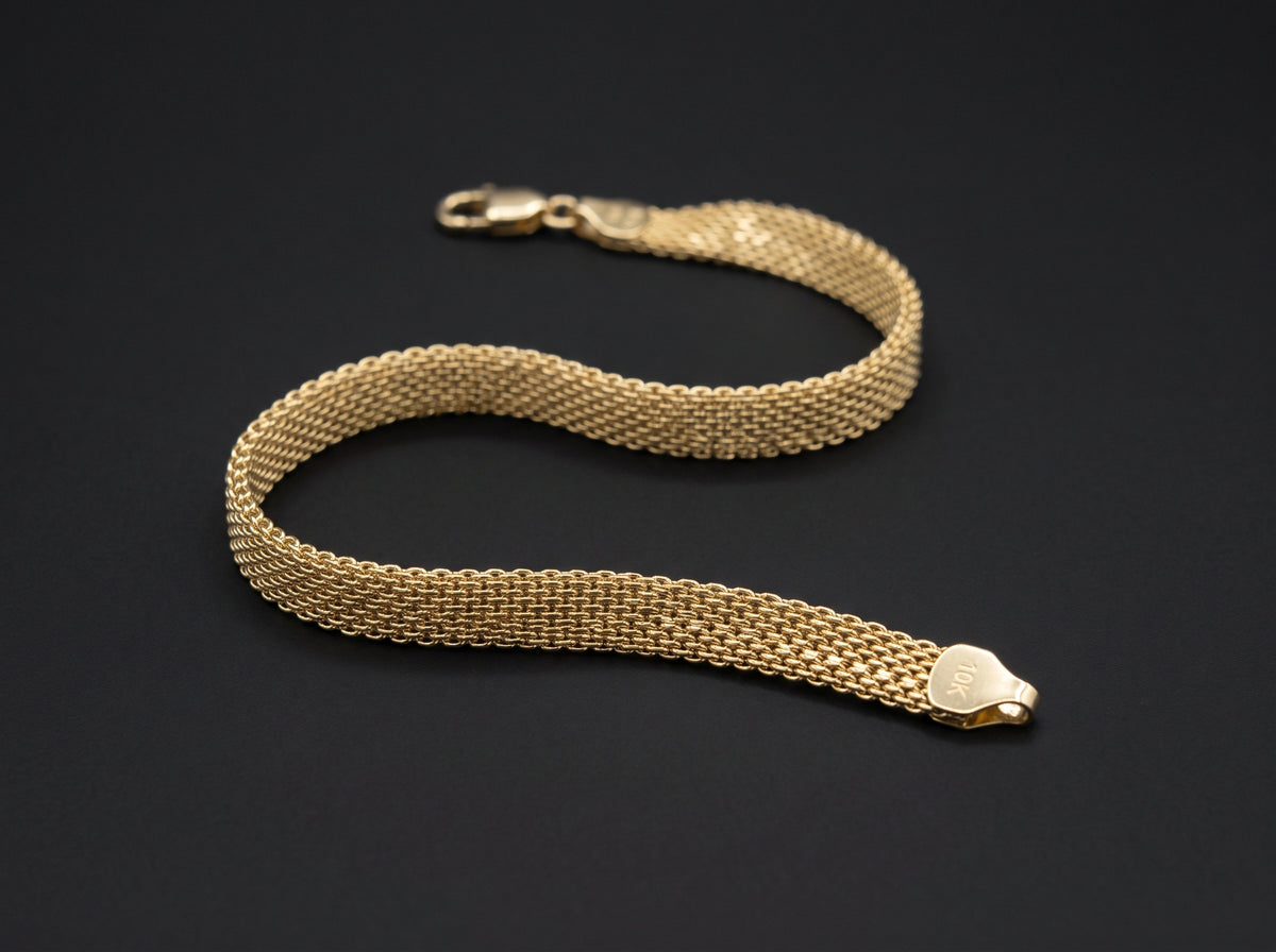 A 10k Gold Bismarck Bracelet displayed on a dark black background.