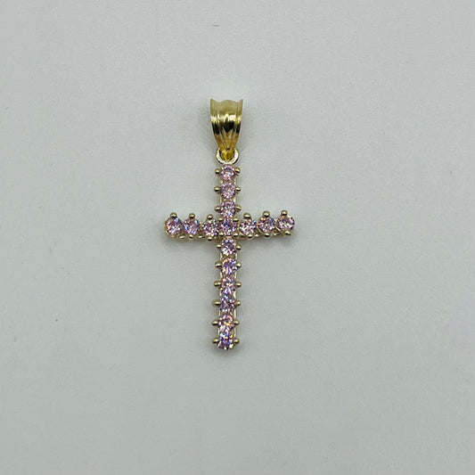 Gold cross pendant with pink gemstones on a light gray background