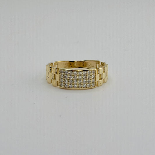 Gold ring with diamond accents on a light gray background