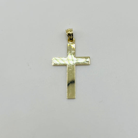 Gold cross pendant on a gray background
