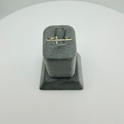 Gold ring in a gray velvet ring box on a light gray background