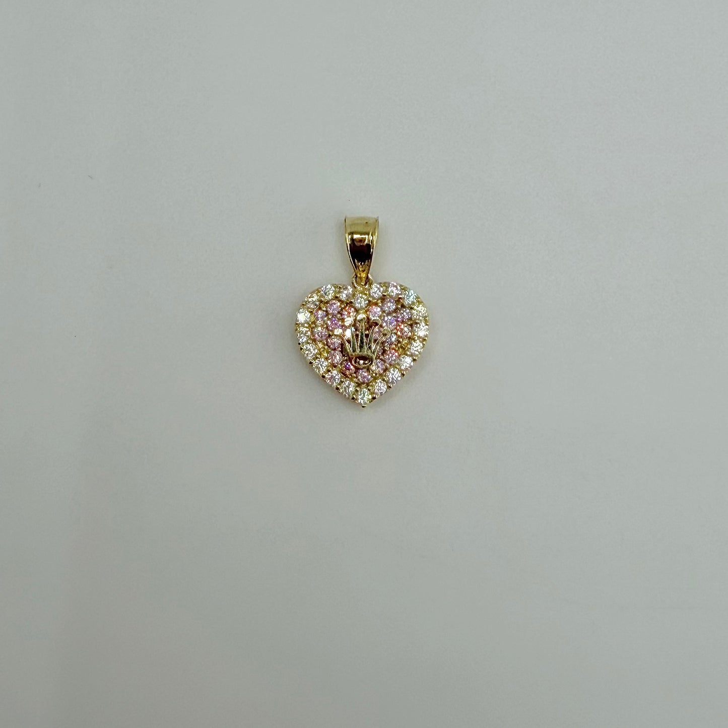 Heart-shaped diamond pendant on a light gray background