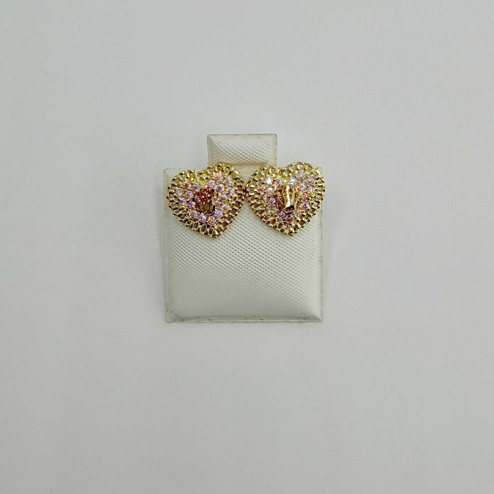 Heart-shaped earrings with gemstones on a white display card against a light gray background