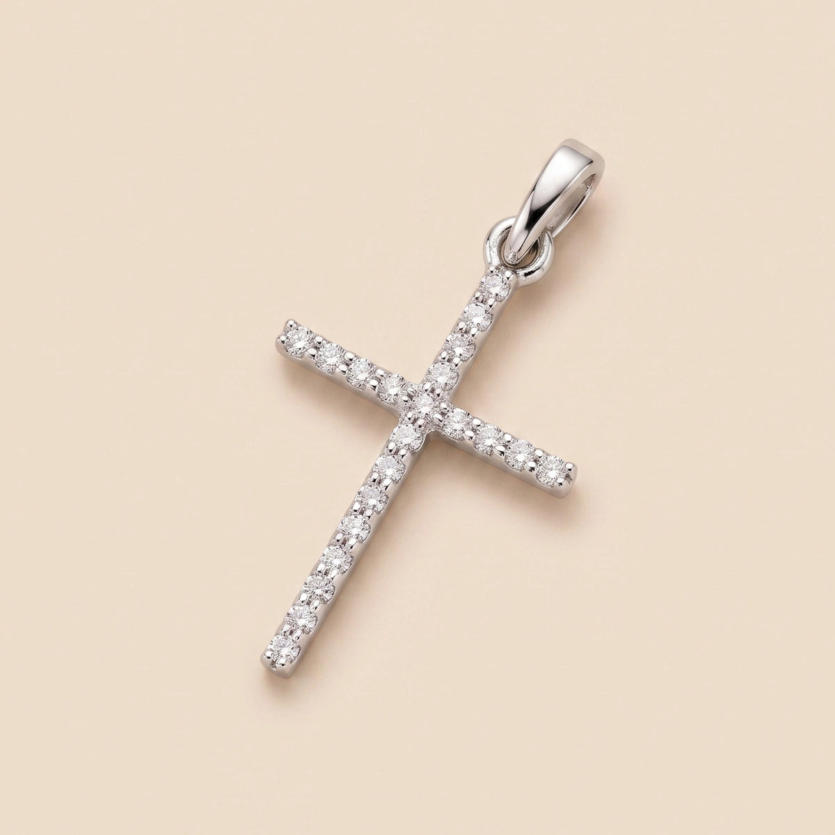 A 14K White Gold Diamond Dainty Cross Pendant featuring a sleek nail-inspired design adorned with delicate diamonds on the bail