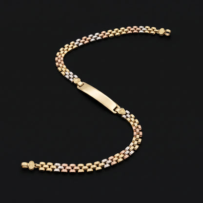 A 14k Gold Solid 4mm Rx Tri -Color Bracelet with a polished yellow gold ID plate, displayed on a solid black background.
