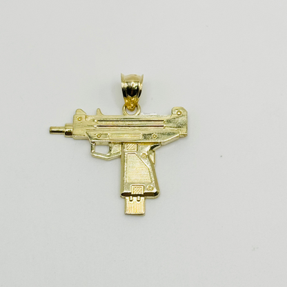 A 10K gold charm designed in the shape of a gun with intricate details, displayed against a white background.