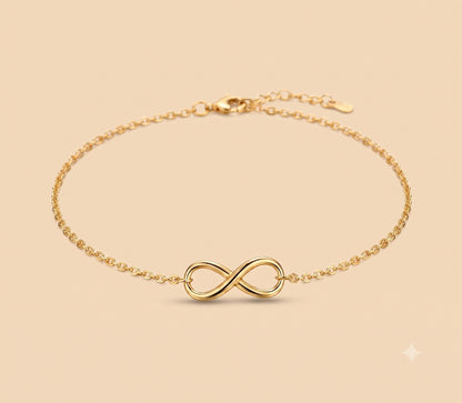 A delicate 10K Gold Infinity Anklet with a polished infinity symbol centerpiece, displayed on a warm beige background.