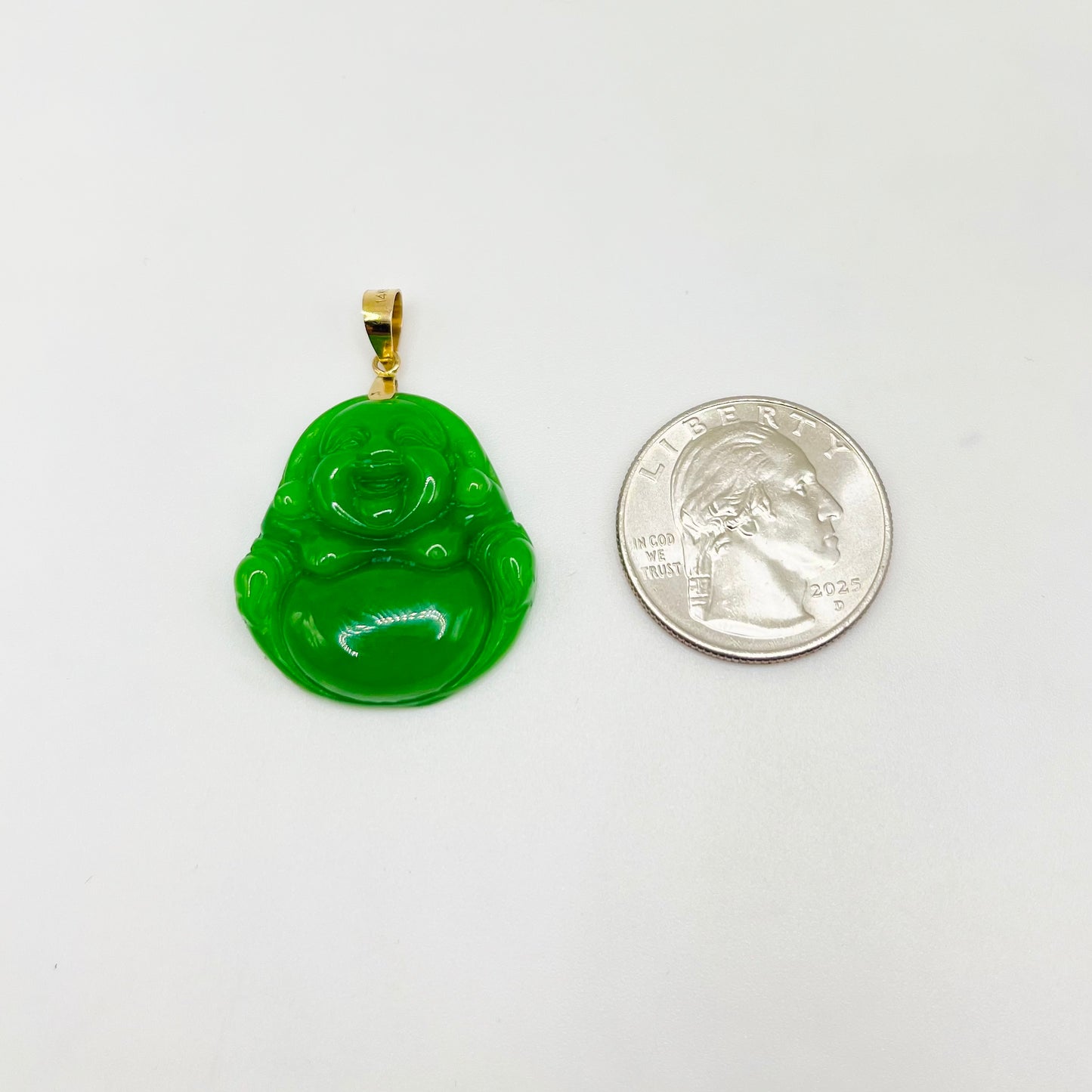 Green Buddha pendant with gold chain next to a U.S. quarter on a white background