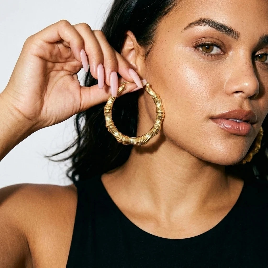10K Gold Bamboo Hoop Earrings (2.25 in) — On Model - Jewelry Hands Detail | Generated by Modelize
